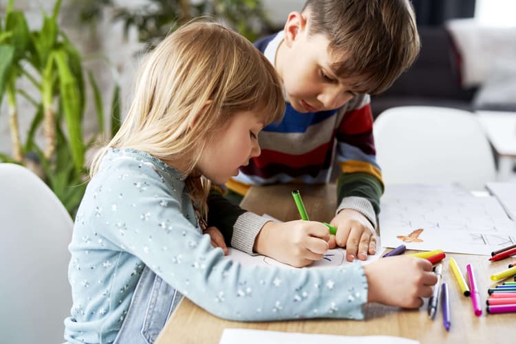 close-up-of-brother-helping-his-sister-with-her-homework